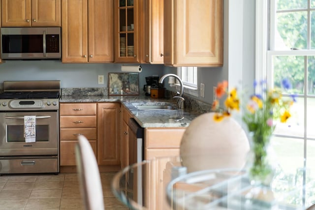 31 Hampton Dr, Stuarts Draft, VA 24477 - kitchen featuring stainless steel appliances, light stone counters, glass insert cabinets, and brown cabinetry