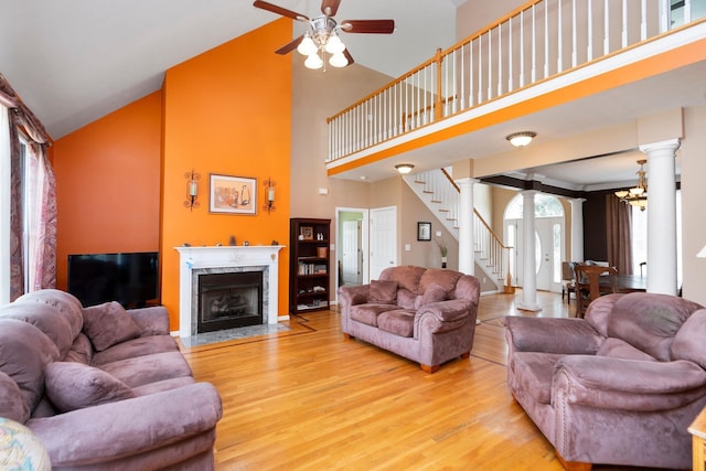 31 Hampton Dr, Stuarts Draft, VA 24477 - living area featuring ornate columns, wood finished floors, stairway, high vaulted ceiling, and ceiling fan