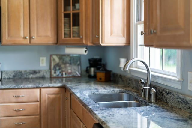 31 Hampton Dr, Stuarts Draft, VA 24477 - kitchen with glass insert cabinets, light stone countertops, and brown cabinets