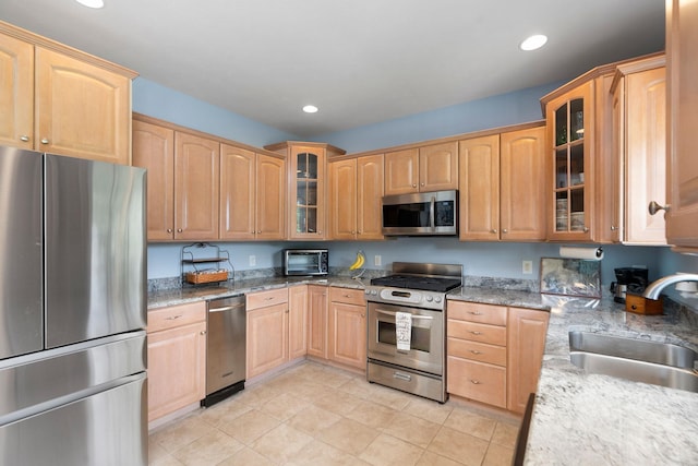 31 Hampton Dr, Stuarts Draft, VA 24477 - kitchen featuring appliances with stainless steel finishes, light brown cabinets, recessed lighting, light stone counters, and glass insert cabinets