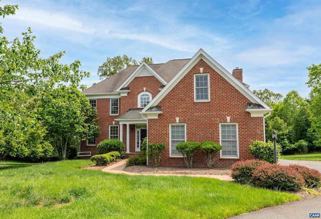 1460 Brentwood Way, Earlysville, VA 22936 - colonial-style house featuring a chimney, brick siding, and a front yard