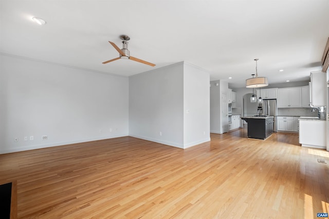 1460 Brentwood Way, Earlysville, VA 22936 - unfurnished living room featuring ceiling fan, light wood-style floors, baseboards, a sink, and recessed lighting