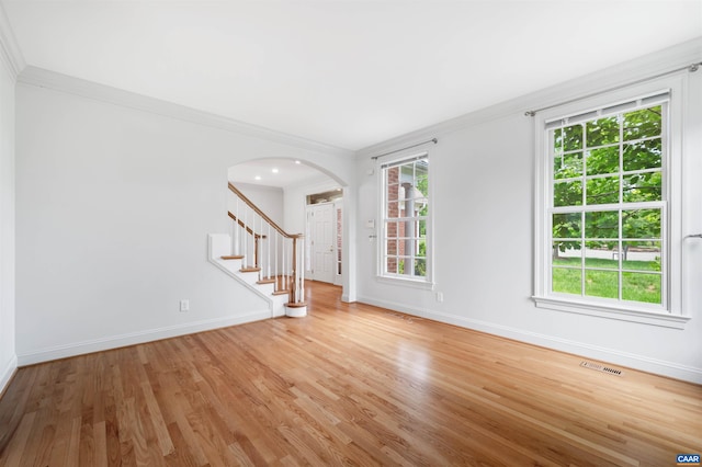 1460 Brentwood Way, Earlysville, VA 22936 - spare room featuring arched walkways, crown molding, light wood-type flooring, baseboards, and stairs