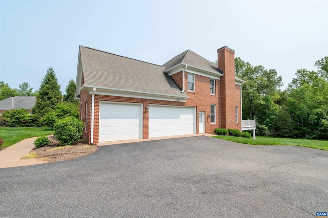 1460 Brentwood Way, Earlysville, VA 22936 - view of side of property with brick siding, a chimney, driveway, a garage, and a shingled roof