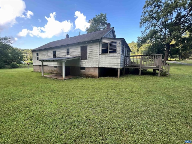 1863 River Rd, Faber, VA 22938 - rear view of property with a wooden deck, a chimney, and a lawn