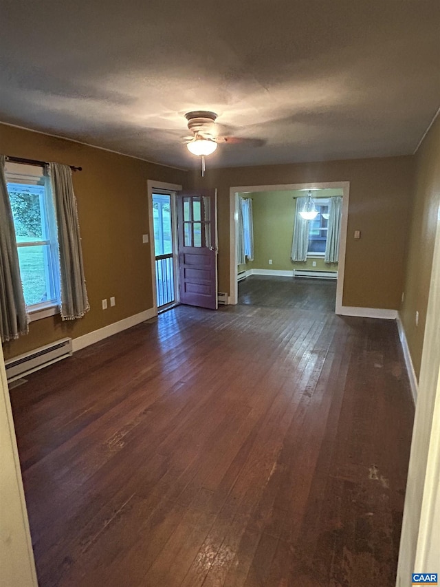 1863 River Rd, Faber, VA 22938 - unfurnished living room with baseboard heating, dark wood-style floors, and a ceiling fan