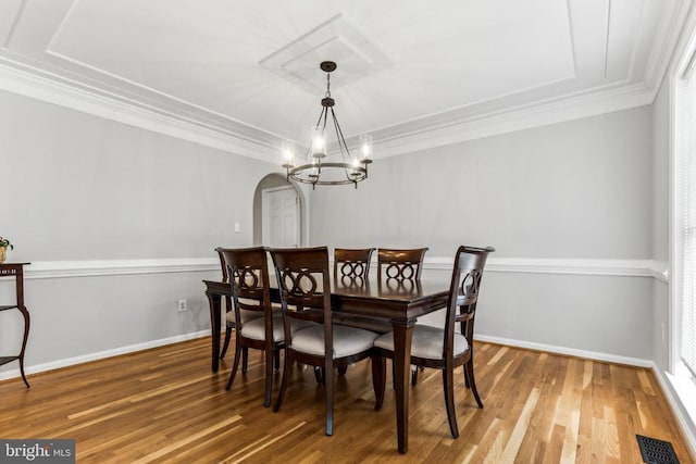 3803 Fallwood Ln, Fredericksburg, VA 22408 - dining room with a chandelier, wood finished floors, crown molding, arched walkways, and baseboards