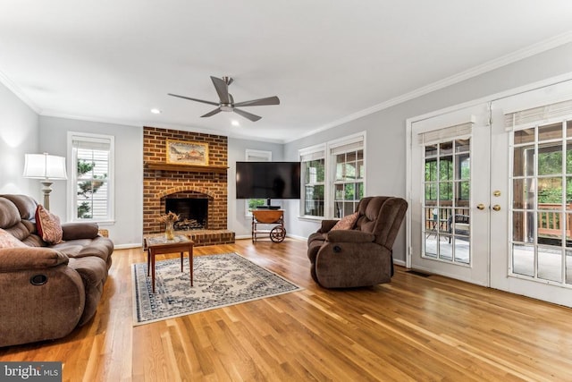 3803 Fallwood Ln, Fredericksburg, VA 22408 - living room featuring ceiling fan, wood finished floors, crown molding, plenty of natural light, and a brick fireplace