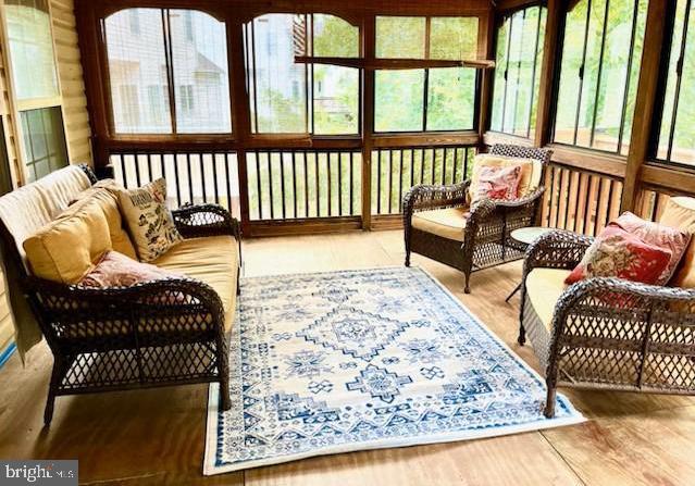 3803 Fallwood Ln, Fredericksburg, VA 22408 - sunroom / solarium featuring healthy amount of natural light, an outdoor hangout area, and wood finished floors