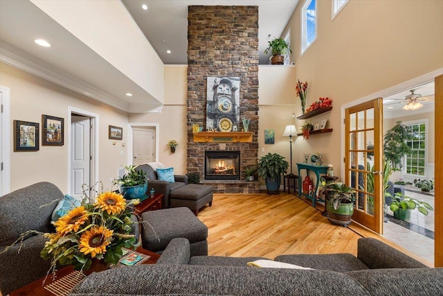 515 Legrande Ave, Waynesboro, VA 22980 - living area with a stone fireplace, wood finished floors, healthy amount of natural light, crown molding, and a high ceiling
