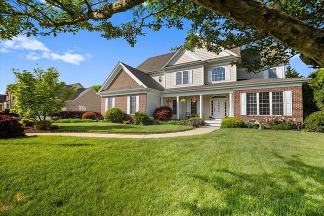 515 Legrande Ave, Waynesboro, VA 22980 - view of front of house with brick siding, covered porch, and a front lawn
