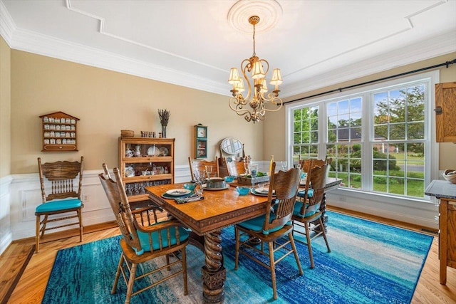 515 Legrande Ave, Waynesboro, VA 22980 - dining space with light wood-type flooring, a chandelier, crown molding, and a wainscoted wall