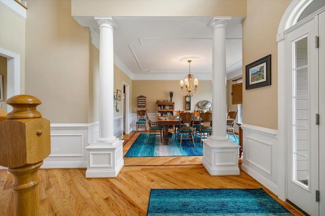 515 Legrande Ave, Waynesboro, VA 22980 - dining area featuring decorative columns, wood finished floors, a chandelier, wainscoting, and a decorative wall