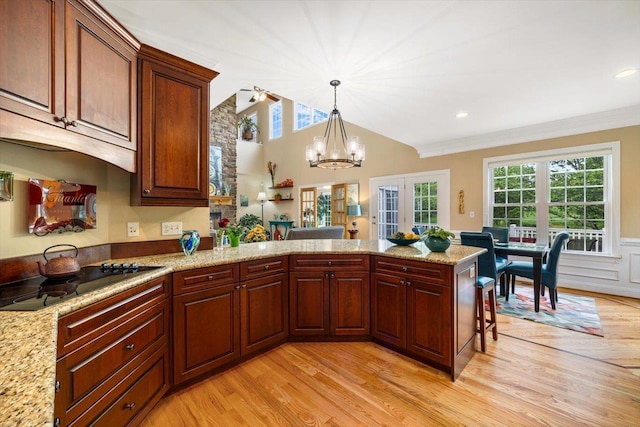 515 Legrande Ave, Waynesboro, VA 22980 - kitchen with black electric cooktop, light wood-style flooring, a peninsula, a chandelier, and wainscoting