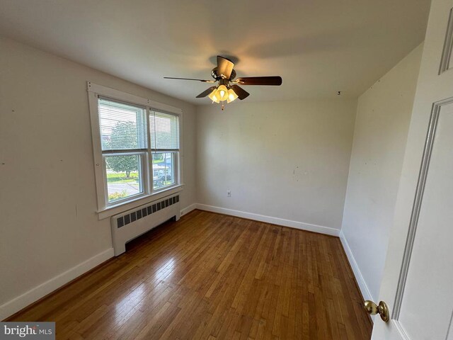 2 Terrace Ln, Luray, VA 22835 - unfurnished room with radiator heating unit, wood finished floors, and a ceiling fan