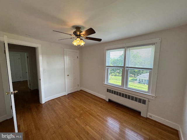 2 Terrace Ln, Luray, VA 22835 - unfurnished bedroom with radiator heating unit, hardwood / wood-style floors, and ceiling fan