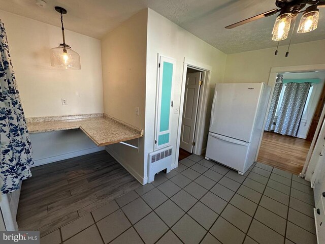2 Terrace Ln, Luray, VA 22835 - kitchen with freestanding refrigerator, ceiling fan, tile patterned flooring, light countertops, and a textured ceiling