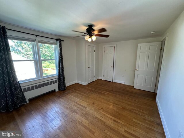 2 Terrace Ln, Luray, VA 22835 - unfurnished bedroom with radiator heating unit, wood-type flooring, and ceiling fan