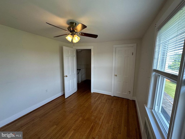 2 Terrace Ln, Luray, VA 22835 - unfurnished bedroom with wood finished floors, multiple windows, and a ceiling fan