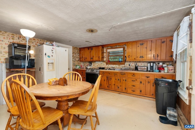 613 6th St, Shenandoah, VA 22849 - kitchen with white fridge with ice dispenser, stainless steel electric stove, brown cabinets, black microwave, and finished concrete flooring