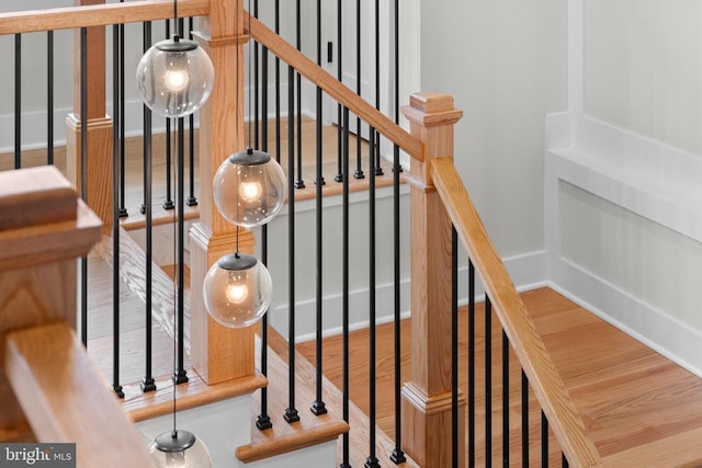  - staircase with wood finished floors and baseboards