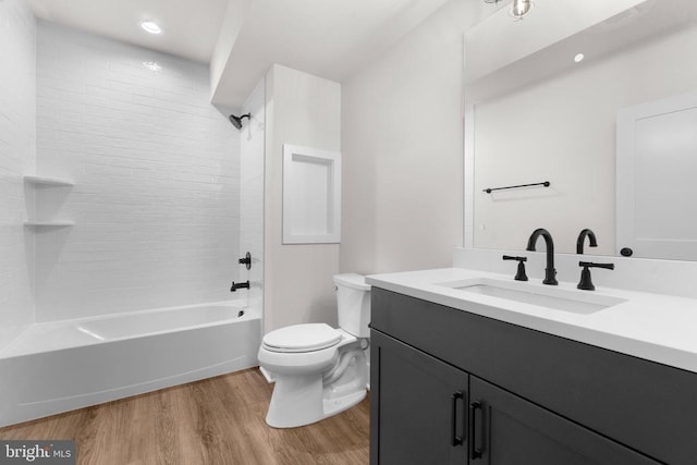  - bathroom featuring vanity, wood finished floors, and bathing tub / shower combination