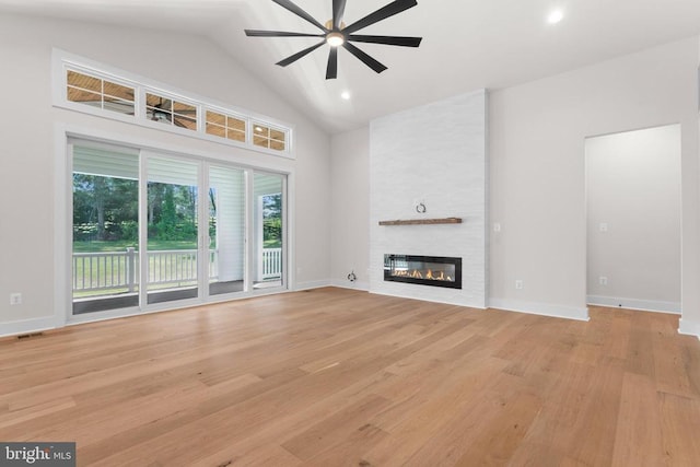  - unfurnished living room with a ceiling fan, a fireplace, light wood-style floors, high vaulted ceiling, and recessed lighting