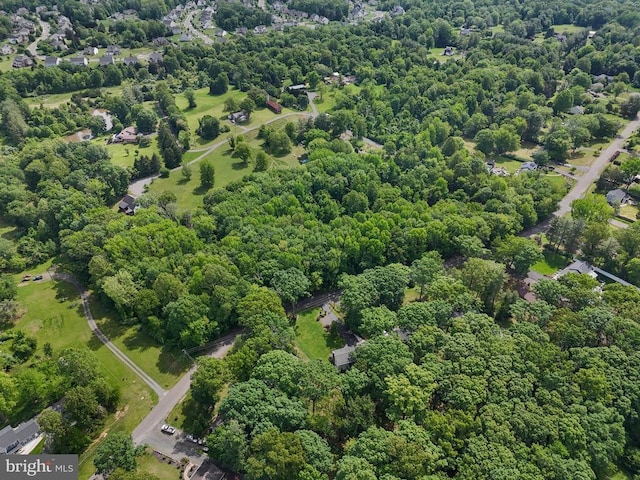  - aerial view of property's location featuring a heavily wooded area