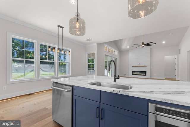  - kitchen with dishwasher, a fireplace, plenty of natural light, recessed lighting, and crown molding