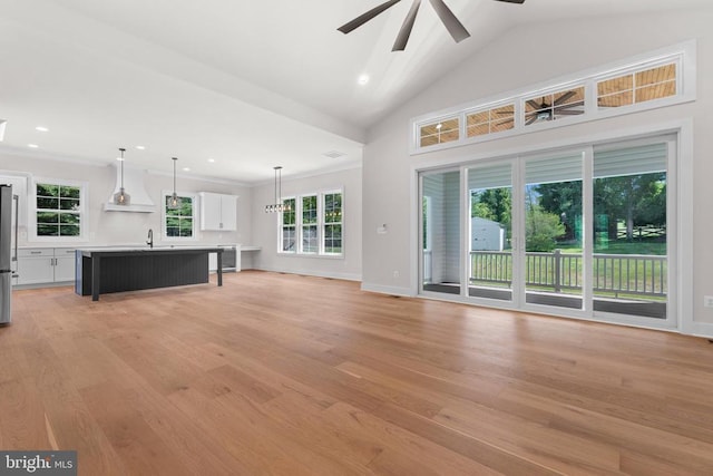  - unfurnished living room with ceiling fan, light wood finished floors, lofted ceiling, and recessed lighting