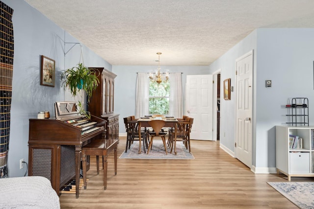 1233 Pinehurst Rd, Staunton, VA 24401 - dining space featuring a chandelier, light wood finished floors, and a textured ceiling