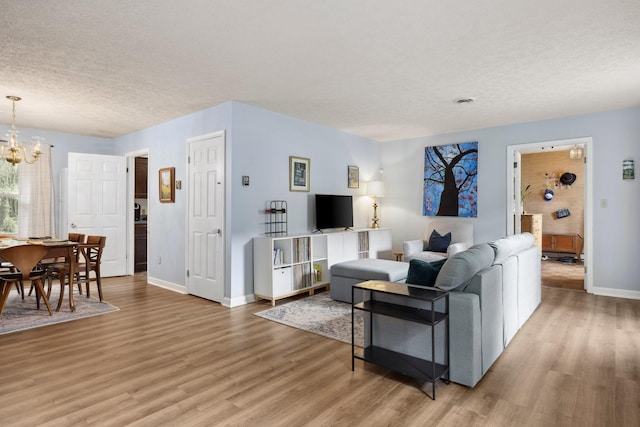 1233 Pinehurst Rd, Staunton, VA 24401 - living area featuring light wood-style flooring, a textured ceiling, and a chandelier