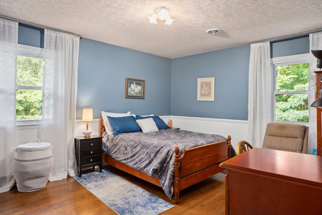 1233 Pinehurst Rd, Staunton, VA 24401 - bedroom with wood finished floors, multiple windows, and a textured ceiling