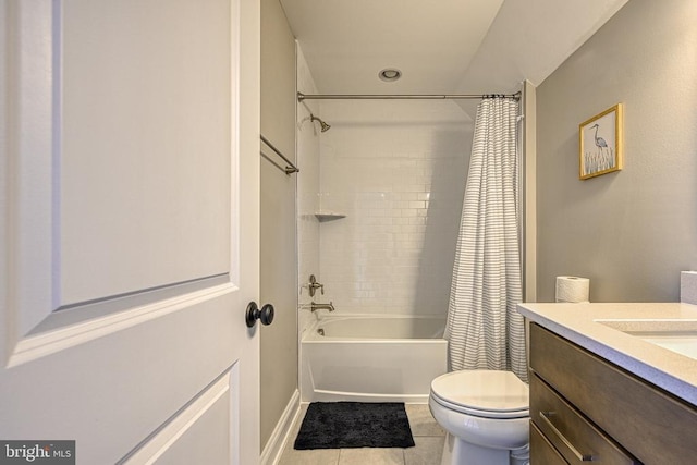 bathroom with toilet, tile patterned floors, vanity, shower / bath combo with shower curtain, and baseboards