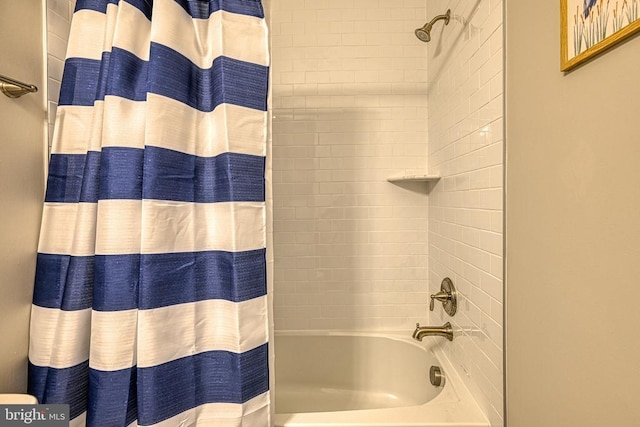 bathroom with shower / bathtub combination with curtain