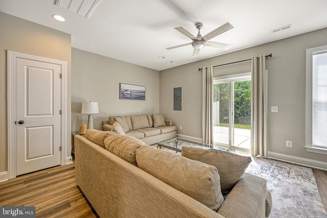 living area with baseboards, wood finished floors, a ceiling fan, and recessed lighting