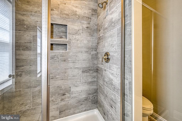 full bath with a stall shower and toilet