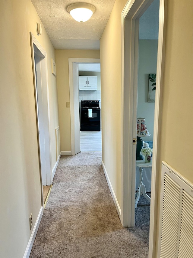1204 3rd St, Waynesboro, VA 22980 - hallway with carpet, a textured ceiling, visible vents, and baseboards