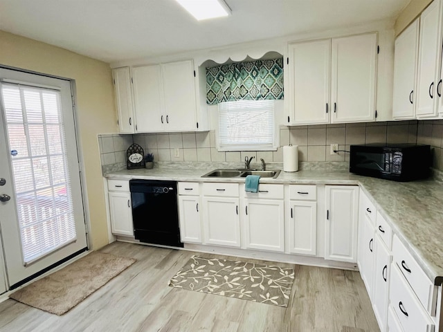 1204 3rd St, Waynesboro, VA 22980 - kitchen featuring a sink, light wood-type flooring, black appliances, and white cabinets
