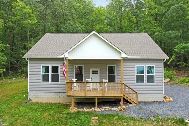 115 Mountain Top Ln, New Market, VA 22844 - view of front of house featuring roof with shingles, a wooded view, and a front lawn