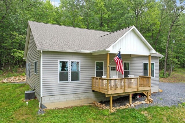 115 Mountain Top Ln, New Market, VA 22844 - view of front facade with a wooden deck, roof with shingles, cooling unit, board and batten siding, and a forest view
