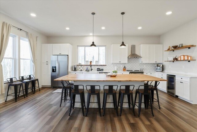 115 Mountain Top Ln, New Market, VA 22844 - kitchen with beverage cooler, a breakfast bar area, stainless steel fridge, wall chimney exhaust hood, and butcher block countertops