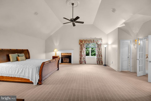  - bedroom featuring carpet floors, vaulted ceiling, a fireplace, and ceiling fan