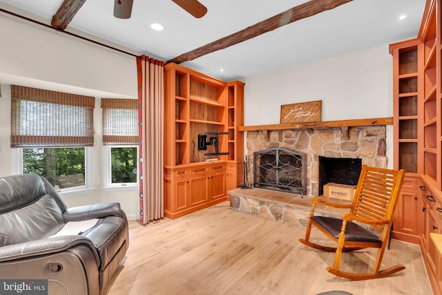  - living room with light wood finished floors, ceiling fan, a fireplace, beamed ceiling, and recessed lighting