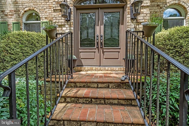  - doorway to property with french doors and stone siding