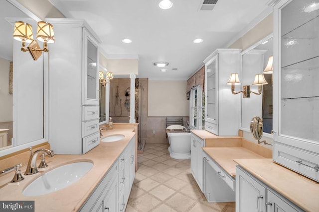  - bathroom with a freestanding tub, tile walls, double vanity, a shower stall, and wainscoting
