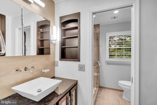  - bathroom with vanity, a stall shower, built in shelves, and tile patterned flooring