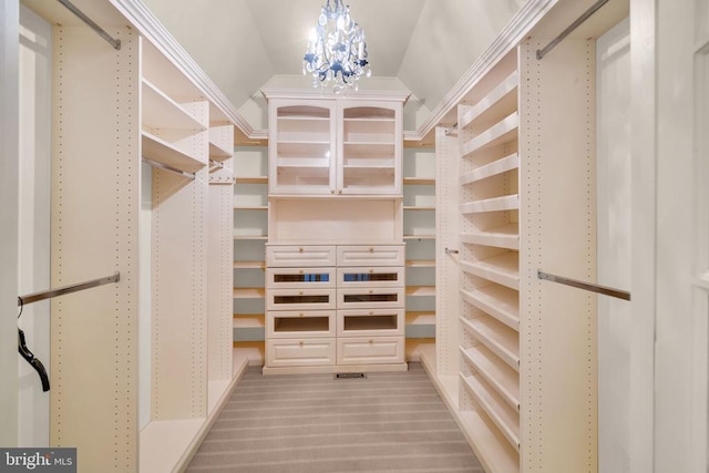  - spacious closet featuring a chandelier and light colored carpet