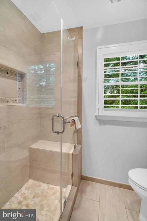  - bathroom with toilet and a stall shower