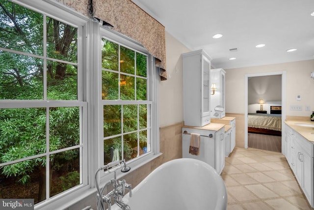  - ensuite bathroom with a freestanding tub, vanity, and recessed lighting